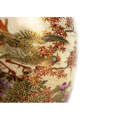 255 - A Japanese Satsuma vase, Meiji period. Gilt decorated with flowering trees and birds in a mountainou... 