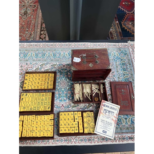 28 - A mahogany cased mahjong set. The lift up front with character marks, opening to reveal five drawers... 