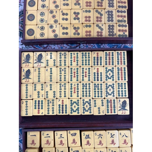 28 - A mahogany cased mahjong set. The lift up front with character marks, opening to reveal five drawers... 