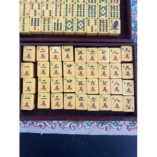 28 - A mahogany cased mahjong set. The lift up front with character marks, opening to reveal five drawers... 