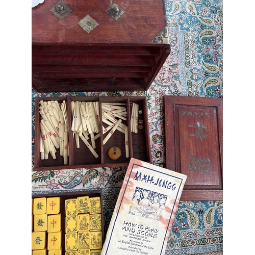 28 - A mahogany cased mahjong set. The lift up front with character marks, opening to reveal five drawers... 