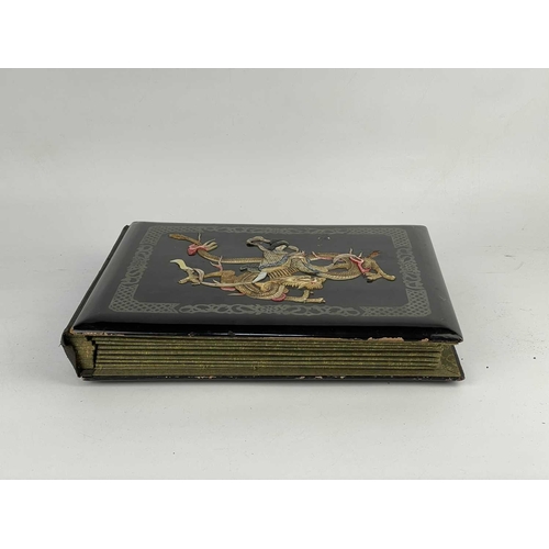 288 - A Japanese black lacquered and silk lined postcard album, early 20th century. Containing seventy-two... 