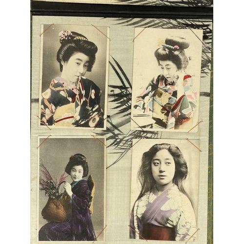 289 - A Japanese black lacquered and silk lined postcard album, early 20th century. Containing seventy-two... 