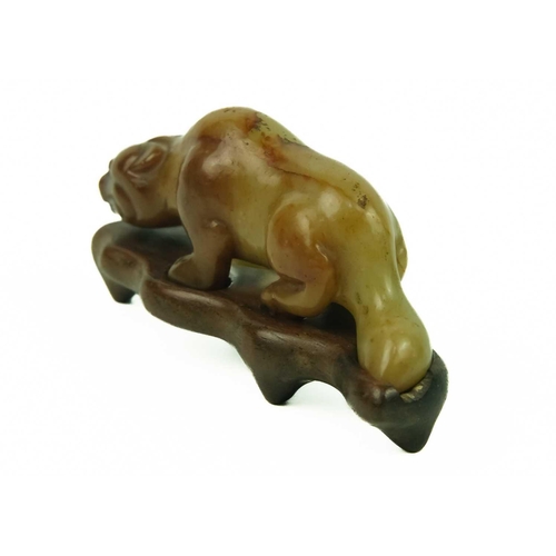 3 - A Chinese russet jade tiger, Qing Dynasty, 19th century. Height 3cm, length 7.3cm, depth 2cm, on a f... 