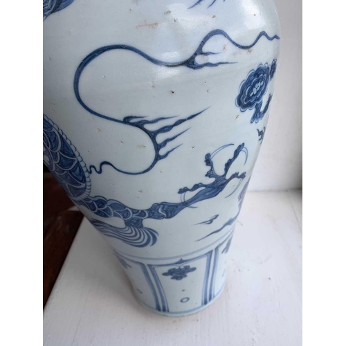 301 - A Chinese blue and white porcelain meiping, 20th century, in Yuan style, painted with a dragon among... 