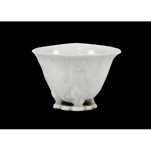 328 - A Chinese blanc de chine libation cup, Qing Dynasty, 18th century. With leafy floral decoration, hei... 