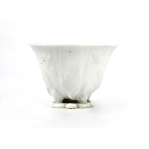 328 - A Chinese blanc de chine libation cup, Qing Dynasty, 18th century. With leafy floral decoration, hei... 