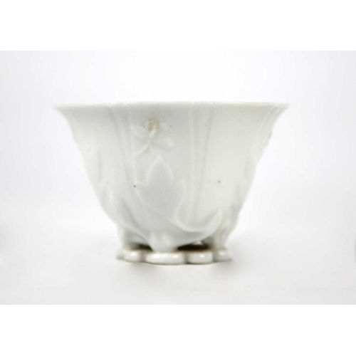 328 - A Chinese blanc de chine libation cup, Qing Dynasty, 18th century. With leafy floral decoration, hei... 