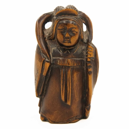 346 - A Japanese carved boxwood netsuke, signed, late Meiji period. In the form of a lady standing, height... 