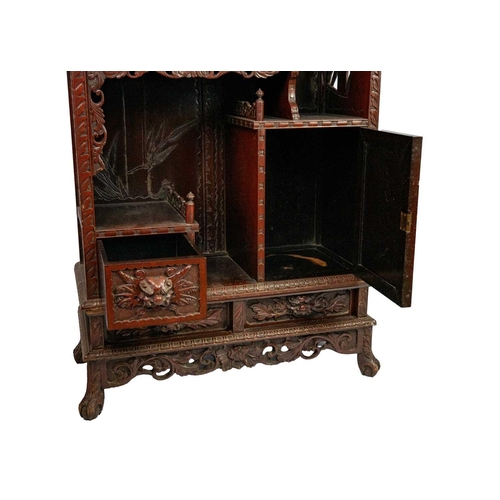 347 - A Chinese red lacquered display cabinet on stand, early-mid 20th century. The pediment carved with a... 