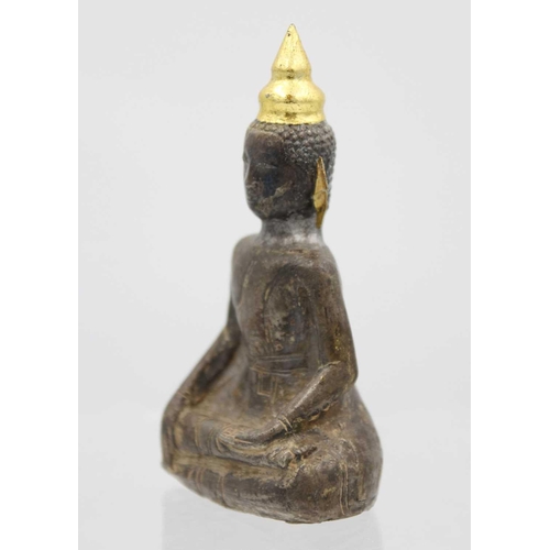 362 - A Chinese silver and wood Buddha, Qing Dynasty, 18th/19th century. In seated pose with gold ears, he... 