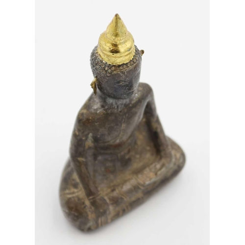 362 - A Chinese silver and wood Buddha, Qing Dynasty, 18th/19th century. In seated pose with gold ears, he... 