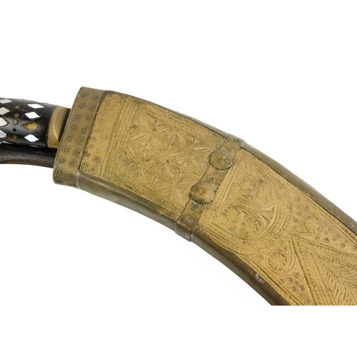 379 - A Nepalise Kukri, early 20th century. With carved wood grotesque mask handle and acanthus leaf engra... 