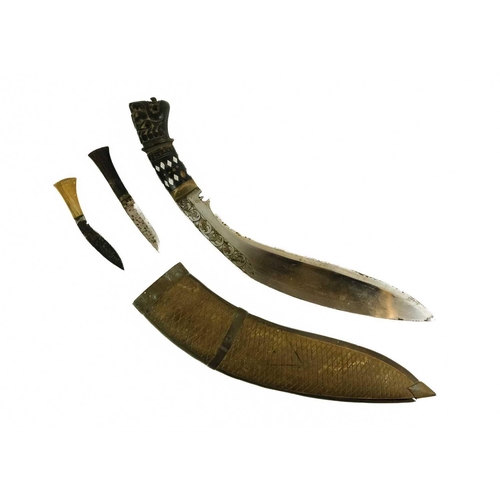 379 - A Nepalise Kukri, early 20th century. With carved wood grotesque mask handle and acanthus leaf engra... 