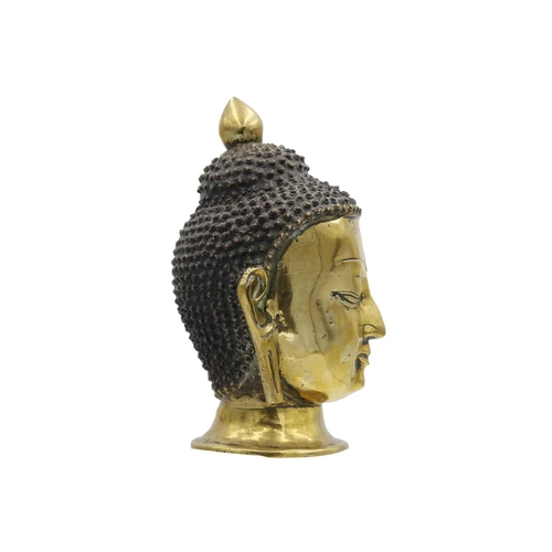 381 - A Sino-Tibetan gilt bronze head of a Buddha, 19th century. With elongated earlobes and tightly curle... 