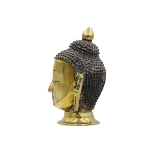 381 - A Sino-Tibetan gilt bronze head of a Buddha, 19th century. With elongated earlobes and tightly curle... 