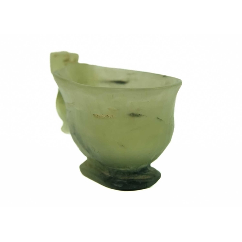 4 - A small Chinese jade and black nephrite libation cup, Qing Dynasty. Height 2.5cm, width 5cm, depth 2... 