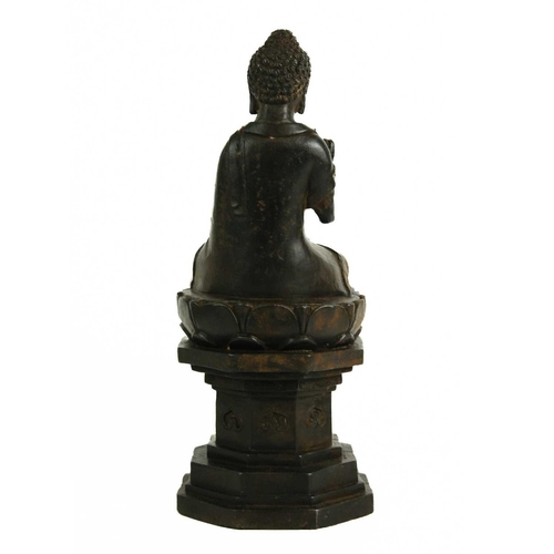 466 - A Chinese cast iron model of Buddha, late 19th century. Seated on an octagonal pedestal, height 30cm... 