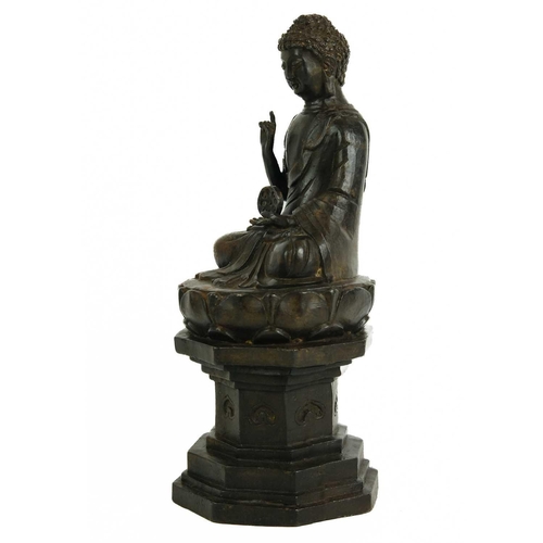 466 - A Chinese cast iron model of Buddha, late 19th century. Seated on an octagonal pedestal, height 30cm... 