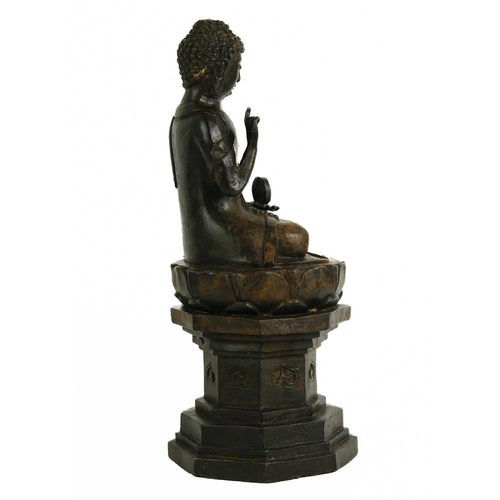 466 - A Chinese cast iron model of Buddha, late 19th century. Seated on an octagonal pedestal, height 30cm... 