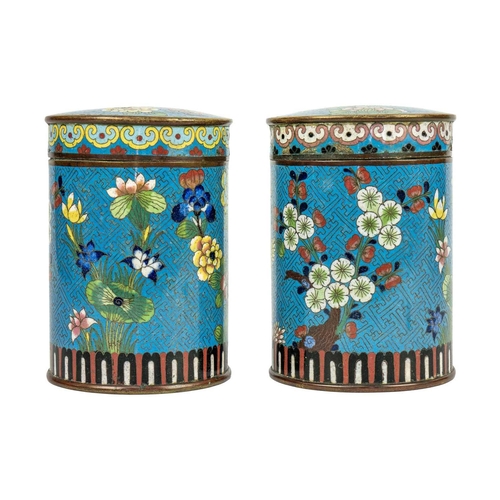 58 - A pair of Chinese cloisonne cylindrical jars and covers, early 19th century. Each with a pale blue g... 