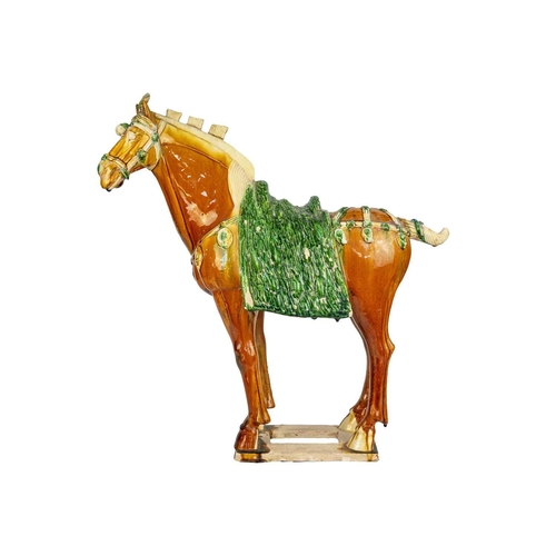 608 - A large Chinese Tang style sancai model of a horse. Height 58cm, length 54cm, depth 22cm.