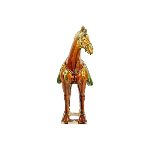 608 - A large Chinese Tang style sancai model of a horse. Height 58cm, length 54cm, depth 22cm.