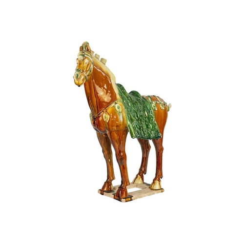 608 - A large Chinese Tang style sancai model of a horse. Height 58cm, length 54cm, depth 22cm.