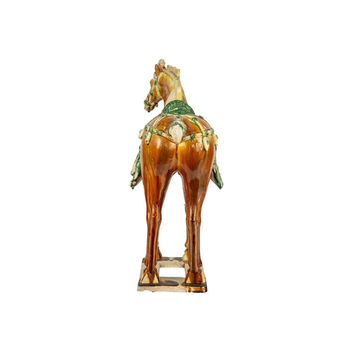 608 - A large Chinese Tang style sancai model of a horse. Height 58cm, length 54cm, depth 22cm.