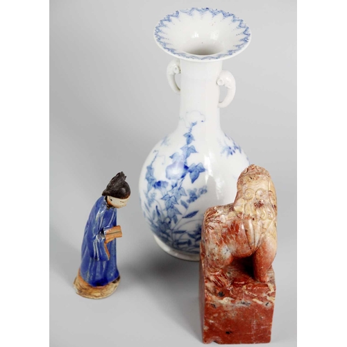 609 - A Chinese blue glazed pottery figure of a tomb attendant holding a scroll. Height 15cm, width 4.5cm;... 