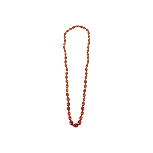 613 - An amber style graduated oval bead necklace. Length 47cm. 97 grams.