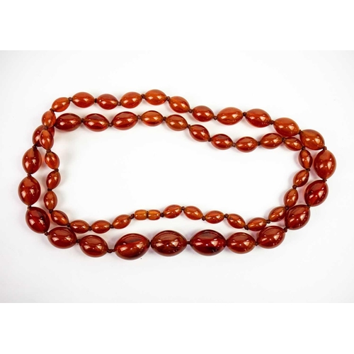 613 - An amber style graduated oval bead necklace. Length 47cm. 97 grams.