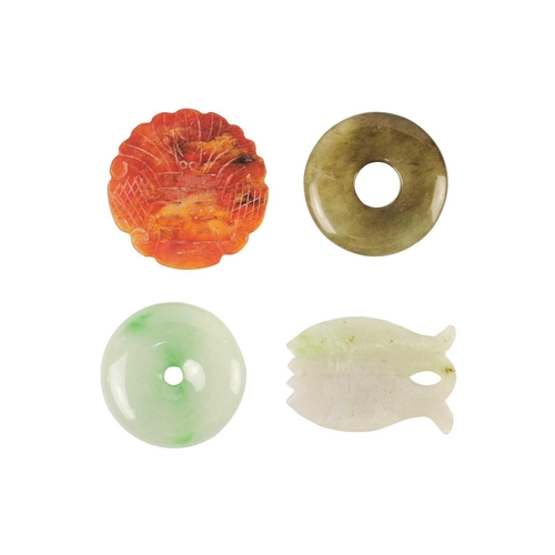 617 - A Chinese jade disc. Diameter 5cm; a Chinese jade fish pendant, 6 x 4cm, and two hardstone discs, di... 