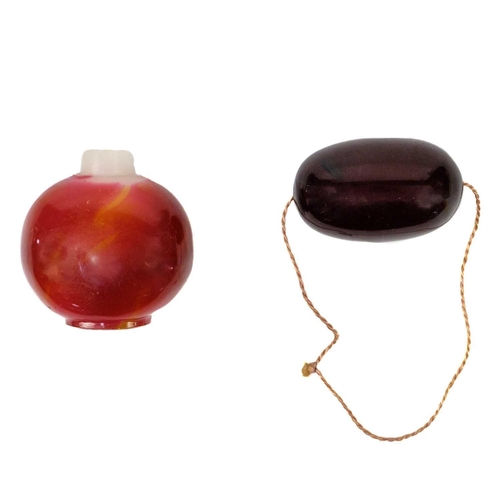 621 - A large bakelite cherry amber bead,. Length 5cm, width 3cm, depth 2.5cm, 38 grams and a Chinese glas... 