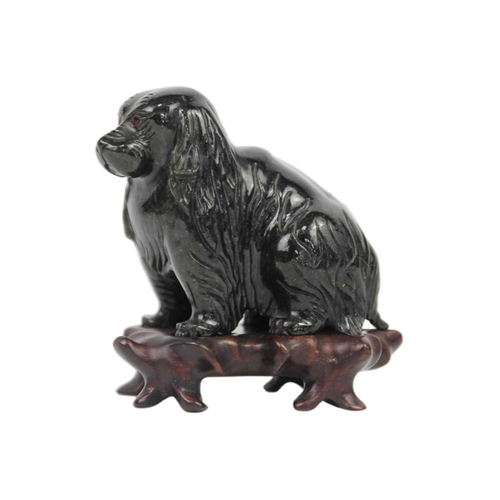 649 - A Chinese carved jade model of a dog. On original wooden stand, total height 10cm, width 10cm, depth... 