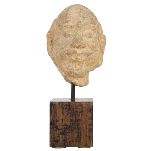 659 - A Chinese ancient carved stone head of a man. Raised on an ebonised wooden block plinth, total heigh... 