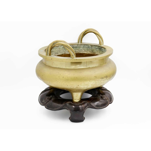 66 - A large Chinese bronze twin-handled tripod censer on stand, Qing Dynasty. Of compressed globular for... 