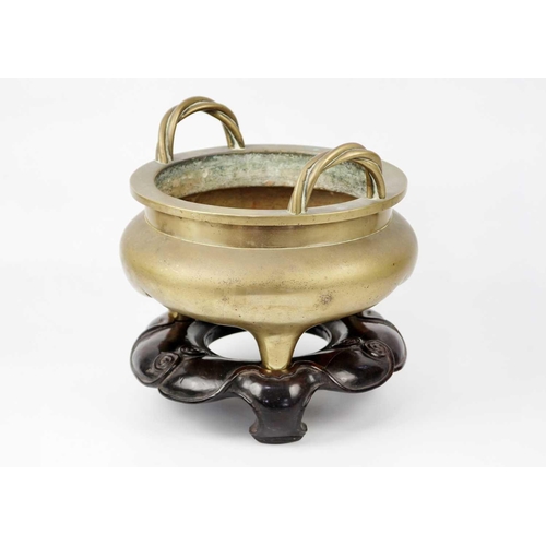 66 - A large Chinese bronze twin-handled tripod censer on stand, Qing Dynasty. Of compressed globular for... 