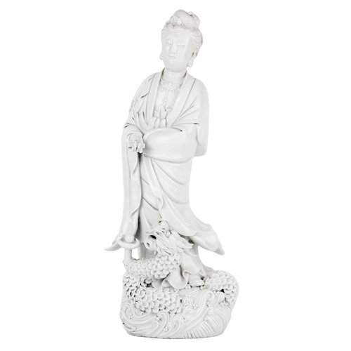 662 - A Chinese blanc de chine figure of Guanyin and dragon, early 20th century. 'He Chaozong' mark to ver... 