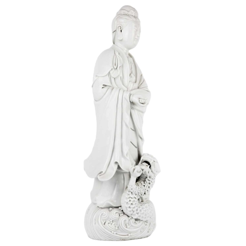 662 - A Chinese blanc de chine figure of Guanyin and dragon, early 20th century. 'He Chaozong' mark to ver... 