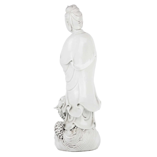 662 - A Chinese blanc de chine figure of Guanyin and dragon, early 20th century. 'He Chaozong' mark to ver... 