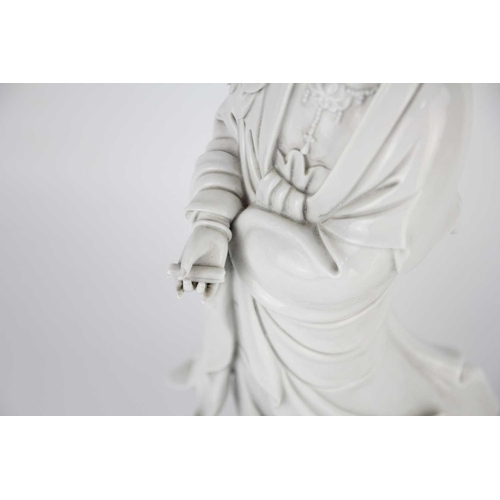 662 - A Chinese blanc de chine figure of Guanyin and dragon, early 20th century. 'He Chaozong' mark to ver... 