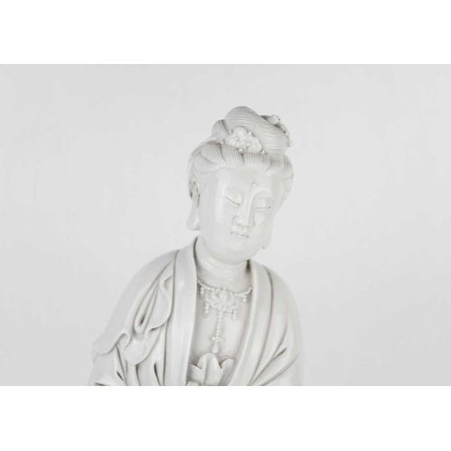 662 - A Chinese blanc de chine figure of Guanyin and dragon, early 20th century. 'He Chaozong' mark to ver... 