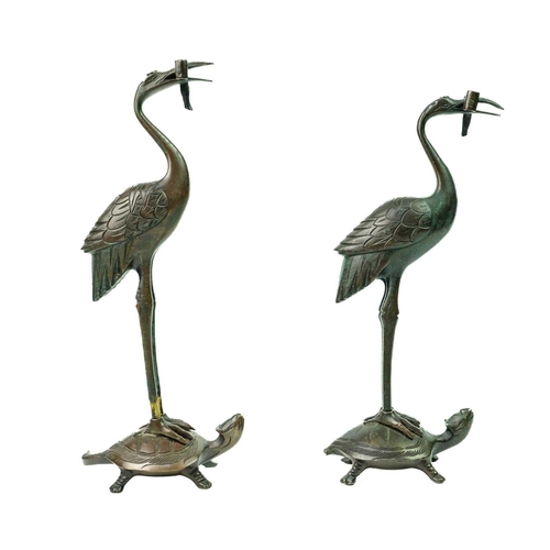 67 - A pair of Japanese bronze figures of storks, Meiji period. Each perched on the back of stylised turt... 