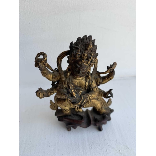 81 - A Sino-Tibetan gilt bronze figure of Mahakala, 18th/19th century. With six arms, his flame like tuft... 