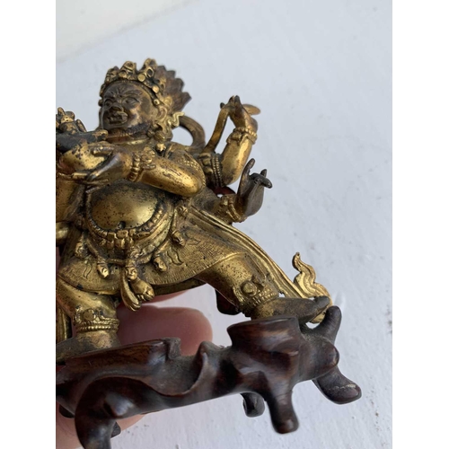 81 - A Sino-Tibetan gilt bronze figure of Mahakala, 18th/19th century. With six arms, his flame like tuft... 