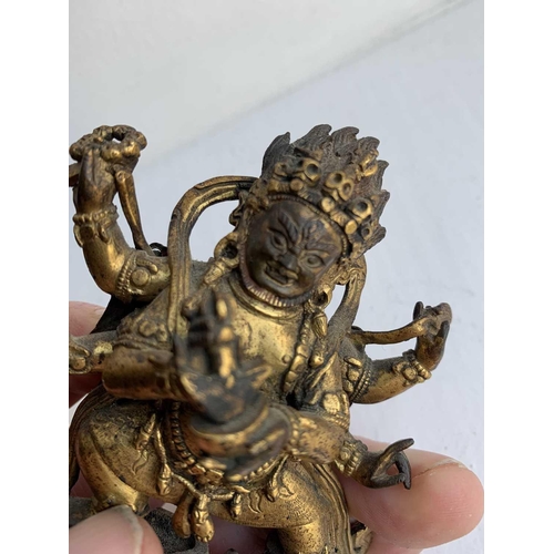 81 - A Sino-Tibetan gilt bronze figure of Mahakala, 18th/19th century. With six arms, his flame like tuft... 