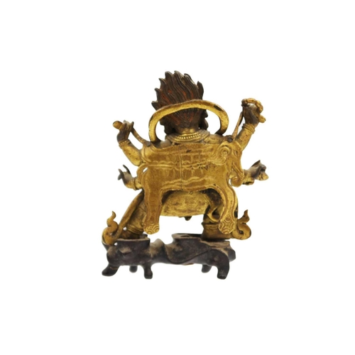 81 - A Sino-Tibetan gilt bronze figure of Mahakala, 18th/19th century. With six arms, his flame like tuft... 