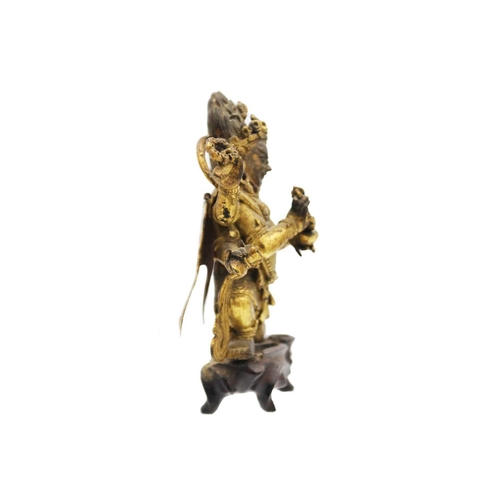 81 - A Sino-Tibetan gilt bronze figure of Mahakala, 18th/19th century. With six arms, his flame like tuft... 