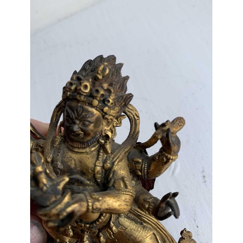 81 - A Sino-Tibetan gilt bronze figure of Mahakala, 18th/19th century. With six arms, his flame like tuft... 